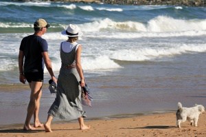 Man and Woman Walking on The Beach