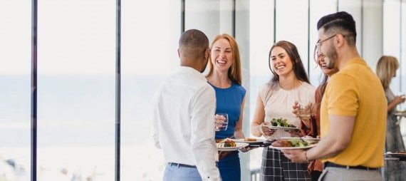 Four people are talking at an in-person event