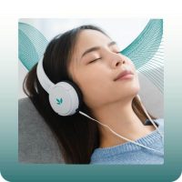 Young woman with closed eyes, listening to music on Unyte headphones, appearing calm and relaxed.