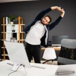 stretching-in-front-of-work-desk